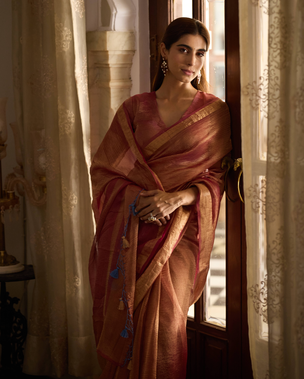 Mṛdula Brick Red Solid Crushed Tissue Saree